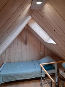 a room with a bed in a attic at Le Séverin : Appartement lumineux et chaleureux in Crécy-en-Ponthieu