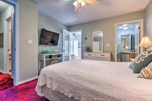a bedroom with a large bed and a flat screen tv at Resort gem w/ 2-bedrooms and easy walk to beach in Panama City Beach