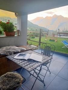 a table and chairs in a room with a view at V&V RentRoom Design in Gignod