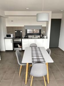 a kitchen with a table and chairs in a kitchen at Departamento Cordillera in Godoy Cruz