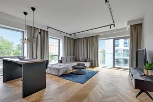 a living room with a couch and a table at Wave Apartments - Yacht Park 2 in Gdynia