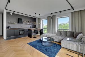 a living room with a couch and a table at Wave Apartments - Yacht Park 2 in Gdynia
