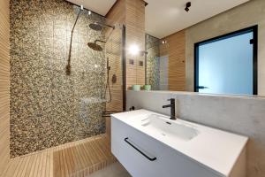 a bathroom with a sink and a shower at Wave Apartments - Yacht Park 2 in Gdynia +11 photos