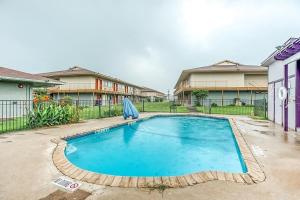 a swimming pool in a yard with houses at Studio Suites in San Antonio