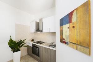 a kitchen with a sink and a stove at Oasis Hotel Residence Resort in Lampedusa