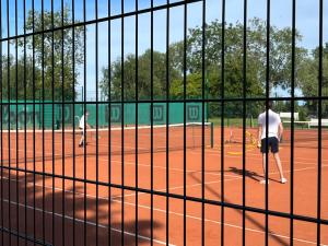 two men playing baseball on a baseball field at Haapsalu Posti in Haapsalu