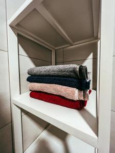 a pile of towels sitting on a shelf at The Brengova house in Mala Nedelja