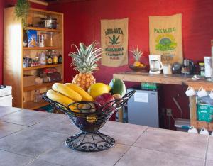 a bowl of fruit on a table in a kitchen at Open Gate Hostel Hawaii in Pahoa