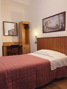 Postel nebo postele na pokoji v ubytování Hotel Umbria
