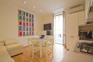 a kitchen and living room with a table and chairs at Alassio bnb Apartments in Alassio