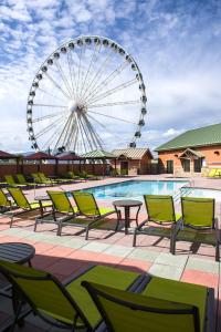 a patio area with tables, chairs and umbrellas at Margaritaville Island Hotel in Pigeon Forge