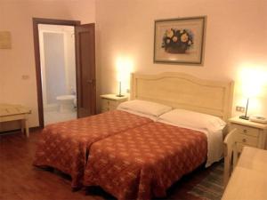 Postel nebo postele na pokoji v ubytování Hotel Umbria