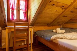 a bedroom with a bed and a wooden ceiling at Kuća za odmor Lara in Otočac