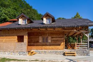 a log cabin with two windows and a roof at Kuća za odmor Lara in Otočac