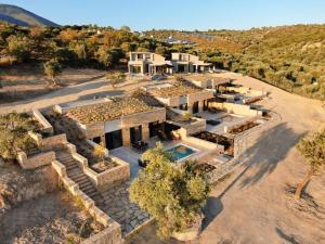 an aerial view of a house with a swimming pool at Fari Stone Villas in Skala Marion