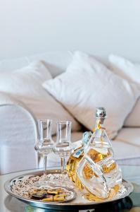 a tray with a bottle and two glasses on a table at Hotel Villa Gabrisa in Positano