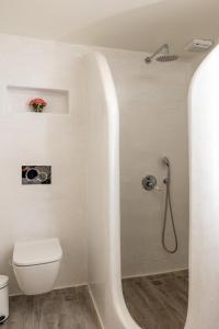 a white bathroom with a toilet and a shower at Ma mer in Naxos Chora