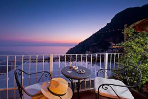 a table and chairs on a balcony with a view of the ocean at Hotel Villa Gabrisa in Positano
