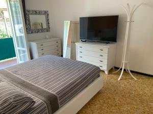um quarto com uma cama e uma televisão de ecrã plano em Appartamento Sandro by PortofinoVacanze em Rapallo