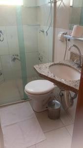 a bathroom with a toilet and a sink and a shower at FlatsRose CH Flamboyant Conforto e qualidade in Goiânia