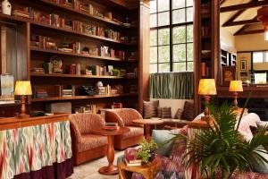 a living room filled with furniture and bookshelves at Life House, Berkshires in Lenox