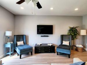 a living room with two chairs and a flat screen tv at ENTIRE HOME- Gorgeous 3br Townhome Pool, Grill, Washer, Dryer, 2 FREE drive up spaces Sleeps 6 Close to everything PCB! in Panama City Beach