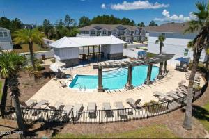 an aerial view of a pool at a resort at ENTIRE HOME- Gorgeous 3br Townhome Pool, Grill, Washer, Dryer, 2 FREE drive up spaces Sleeps 6 Close to everything PCB! in Panama City Beach