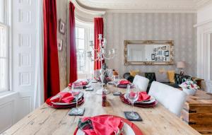 a dining room with a table with wine glasses on it at Heart of Ayr: elegant townhouse in central Ayr in Ayr