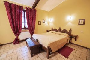 Postel nebo postele na pokoji v ubytování Agriturismo Torre Burchio