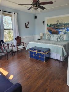 a bedroom with a bed with a blue trunk at The Home Place Inn in Kensington