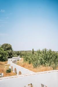 a bridge over a road with trees in the background at O Conventinho in Évora
