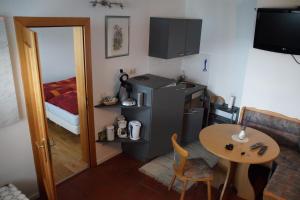 a small kitchen with a small table and a refrigerator at Apartment Sunnseitn am Verditz in Verditz