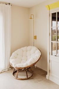 a white couch sitting in a room next to a window at ALDAPA Casa Rural in Laguardia