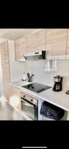 a kitchen with a stove and a stove top oven at Maison 2 Chambres - TV - CLIM - BABY FOOT in Ruelle-sur-Touvre +10 photos