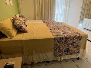 a bed with two pillows on it in a room at Gran Lençois Flat Residence - Barrerinhas (Aptº Particular) in Barreirinhas