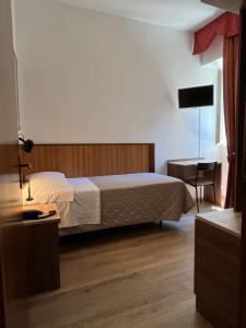 Postel nebo postele na pokoji v ubytování Hotel Umbria