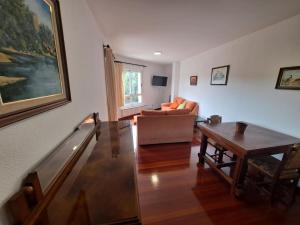 a living room with a couch and a table at Apartamento con vistas, amplio y luminoso in Monforte de Lemos