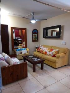 a living room with two couches and a coffee table at Hacienda en Primavera, descanso Familiar total in Puerto Vallarta