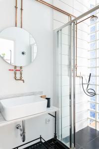 a bathroom with a sink and a shower at MÔSS - Monastiraki Square Suite in Athens