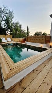 a swimming pool in a backyard with a wooden fence at La dolce Giulia in Hyères