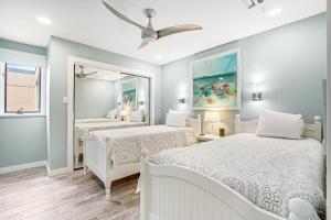 a bedroom with two beds and a mirror at Rehoboth Beach --- 23 Maryland Ave #500 - Tidewater House in Rehoboth Beach