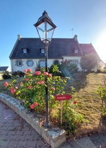 a street light in front of a house with flowers at L'escale d'Armor in Loudéac