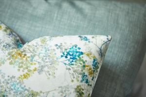 a pillow with a flower pattern on a couch at Willowbeck Lodge Boutique Hotel in Carlisle