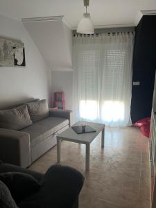 a living room with a couch and a table at APARTAMENTO HERRERIA in Caldas de Reis