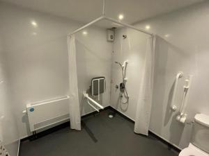 a bathroom with a shower and a toilet at Loch Lomond Hotel in Balloch