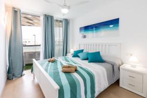 a bedroom with a bed with blue and white at LOLA'S HOME in Cotillo +56 photos