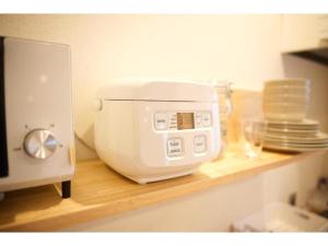 a white mixer sitting on a counter next to plates at Konyamachi Guest House Kuku - Vacation STAY 72725v in Takamatsu