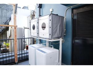 a room with two machines on a balcony at Konyamachi Guest House Kuku - Vacation STAY 72725v in Takamatsu