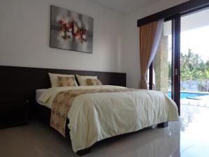 Postel nebo postele na pokoji v ubytování D' Kubu Pratama Homestay