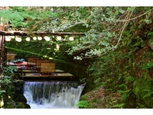 a waterfall in the middle of a forest at cozy house - Vacation STAY 13159 in Kyoto